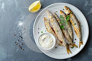 Fried Rainbow Smelt Fish with Tartar Sauce, Small Sea Sardines, Sprats or Roasted Anchovies Snack