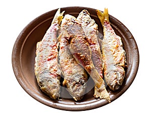 Fried red mullet fishes on plate cut out on white