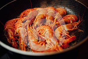 Fried red shrimps with hot oil on pan