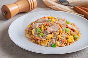 Fried rice chicken with egg and vegetables on white plate