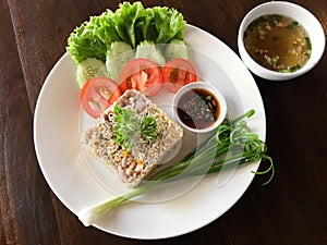 Fried rice with chili sauce and soup on wooden table