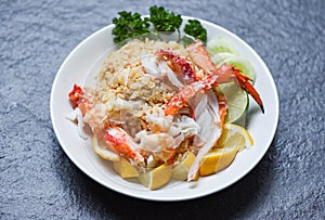 Fried Rice crab seafood - Healthy food fried rice with Crab legs with egg lemon and cucumber on white plate