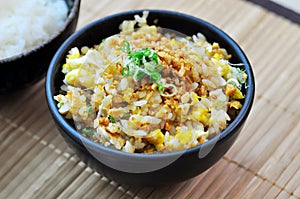 Fried rice with garlic in a black bowl