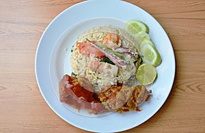 Fried rice with mixed seafood and crispy chicken on plate