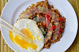 Fried rice noodle and spicy minced pork with basil leaf topping egg