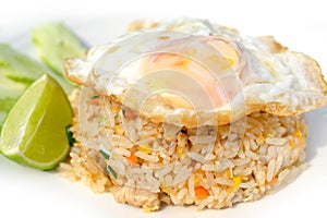 Fried rice with pork or chicken and vegetables topping with fried eggs