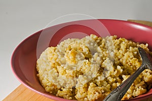 Fried rice on a red plastic plate and a spoon