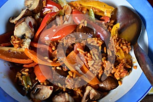 Fried rice with small red and yellow peppers plus mushrooms and spring onions