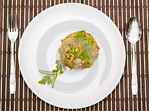 Fried rice yellow curry with pork on bamboo mat