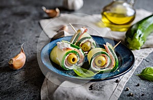 Rolled zucchini slices stuffed with bacon, cream cheese and olive