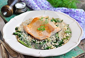 Fried salmon with brown rice, spinach and leguminous kidney bean photo
