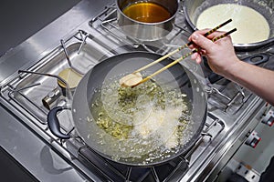 Fried salmon piece in the oil pan