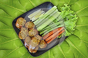 Fried sausage dish serves with fresh vegetables