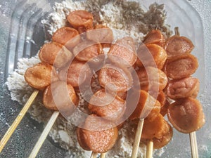 Fried sausage satay which is ready to be coated with flour