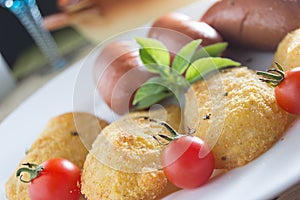 Fried sausages and breaded potatoes