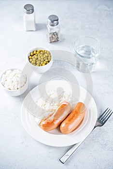 Fried sausages with rice in a plate