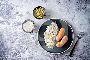 Fried sausages with rice in a plate