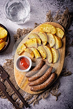 Fried sausages with roasted potato slices