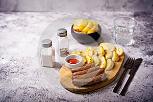 Fried sausages with roasted potato slices