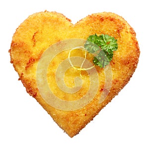 Fried Schnitzel in heart shape, decorated, on white