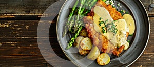 Fried schnitzel with hollandaise and asparagus, top view