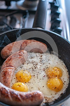 Fried scrambled eggs fried scrambled eggs with sausages in a frying pan