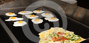 Fried and scrambled eggs and omelette station in a hotel or restaurant setting, catering breakfast