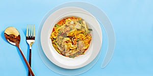 Fried seafood with curry powder on blue background