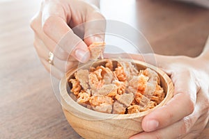 Fried shrimp chins snack in wooden bowl