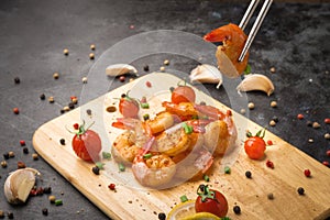 Fried shrimp with garlic and pepper on wood chopping