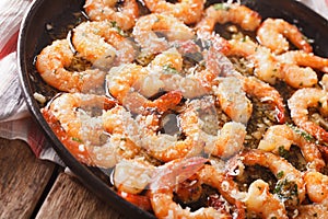 Fried shrimp in garlic sauce with parmesan and herbs closeup. Ho