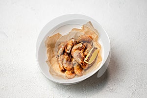 Fried shrimp with spices and lemon. Foodplate on white background. Healthy diet. Seafood concept. Top view. Horizontal