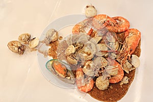 Fried shrimp, squid and shell with black pepper. Thai style Seafood