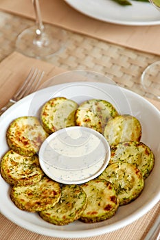 Fried sliced zucchini served with yogurt dip