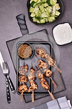 Fried slices of meat on wooden skewers