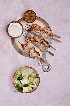 Fried slices of meat on wooden skewers