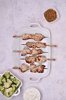 Fried slices of meat on wooden skewers