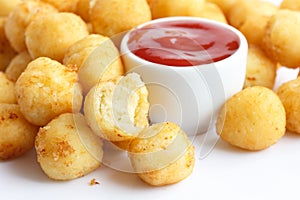 Fried small potato balls on white.