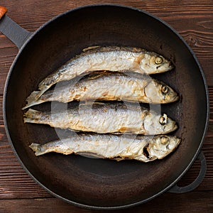 Fried smelt on a frying pan