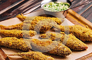 Fried smelt on a wooden chopping board