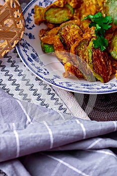 Fried Solanum melongena with Egg in a green dish on the table with garlic, dried chilli