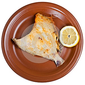 Fried sole fish on brown plate