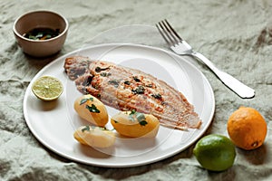 Fried sole fish served with boiled potatoes and parsley sauce
