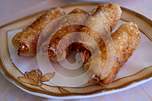 Fried spring rolls on light plate. Delicious Thai spring rolls. Top view