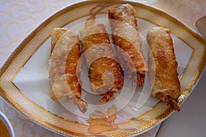 Fried spring rolls on light plate. Delicious Thai spring rolls. Top view