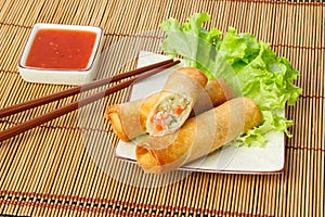 Fried spring rolls, one cut, on a plate