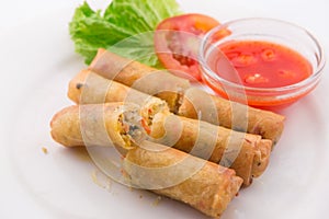 Fried spring rolls with red chilli sauce, tomato and lettuce