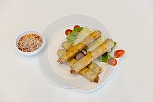 Fried spring rolls with red and white sauces. Deep fried spring roll with sauce on white plate. Crispy spring rolls on dish with v