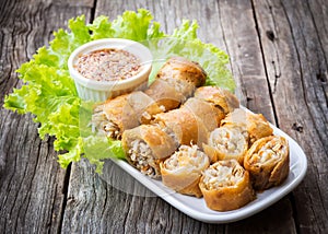 Fried spring rolls. Sliced spring roll served with sweet and spicy sauced. Asian vegetarian appetizer.