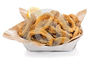 Fried squid rings with lemon isolated on white.